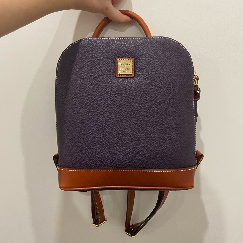 Dooney & Bourke zip pod backpack in the color plum wine. super cute! never used.